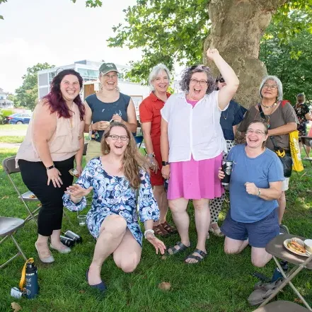 A group of employees outside at a picnic.